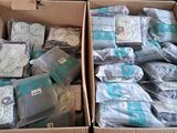 two boxes filled with baby items sitting on a table