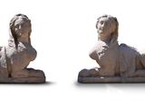 two statues of a dog and a cat on a white surface