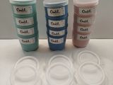 four plastic containers with labels on them are sitting on a table