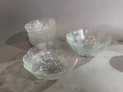 three glass bowls sitting on a table next to each other