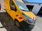 the yellow van is parked in the parking lot next to a building