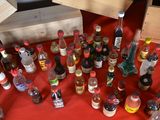 many bottles of alcohol sitting on a red table
