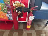 a fire extinguisor next to a fire hydrant on the floor