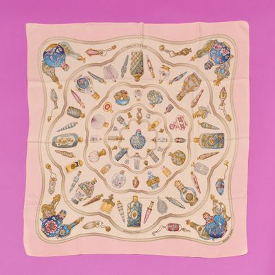 a close up of a square scarf on a pink background