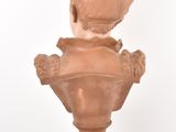 a small statue of a child on a pedestal