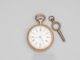 a gold pocket watch with a key attached to it