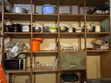 shelves with pots and pans on top of them in a kitchen