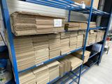 many stacks of cardboards on the shelves in the warehouse
