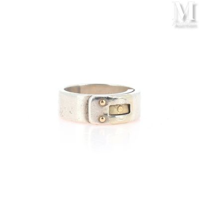 a close up of a silver ring on a white surface