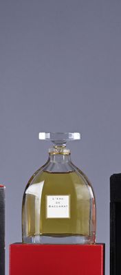 three bottles of perfume sitting next to each other on a table