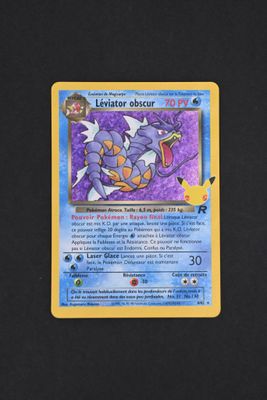 a close up of a pokemon card on a black surface
