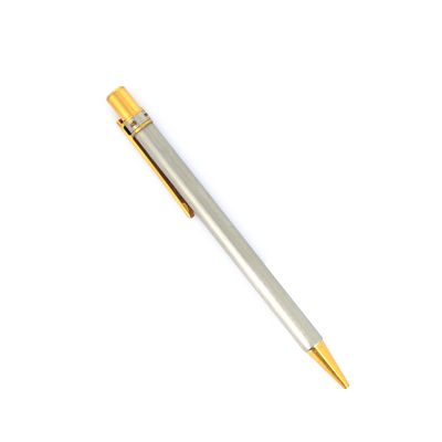 a pen that is laying on a white surface