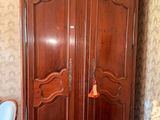 a large wooden armoire in the corner of a room