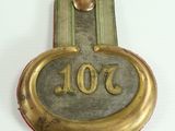 a brass plaque with the number 1003 on it