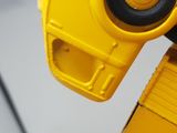 a close up of a yellow toy truck with a camera attached to the back of it