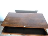 a wooden table with a drawer on top of it