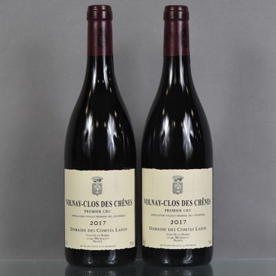 two bottles of wine sitting on top of a table next to each other