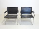 pair of chrome and black leather lounge chairs with armrests