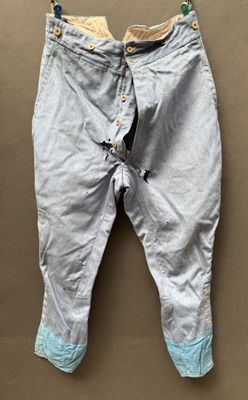 a pair of baby pants hanging on a wall