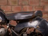 a motorcycle that is parked in front of a brick wall