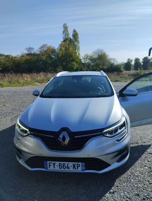 a white car parked next to a silver car in a parking lot