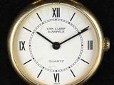 a gold wrist watch with roman numerals on it