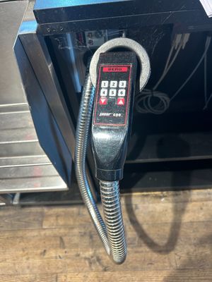 a close up of a metal object with a cord attached to it