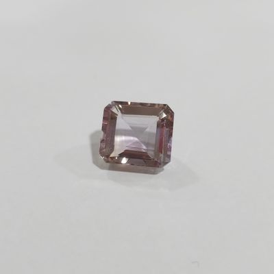 a pink tourmaline gems stone on a white surface