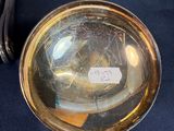 a gold plate with a magnifying glass on it