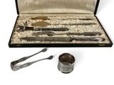 a silverware set in a case with a spoon and spoon rest