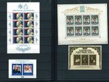several stamps are on display on a black board with a picture of a man and a woman