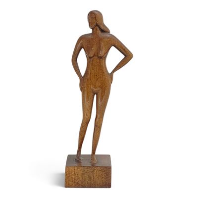 wooden sculpture of a woman standing on a wooden base