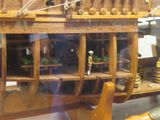 a wooden model of a ship in a display case