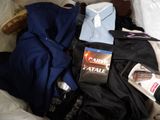 a suitcase full of clothing and a book on the bed