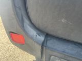 a close up of the rear bumper of a blue car
