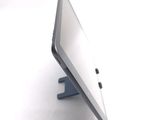 a tablet computer sitting on a stand on a white surface