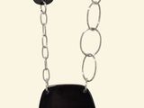 necklace with black stone and silver chain on white background
