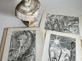 four books with drawings on them on a table
