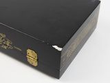 a black box with a gold design on it