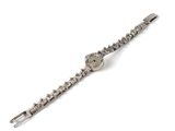 montre-bracelet ornée de pierres cristallines sur fond blanc, posée sur une surface blanche