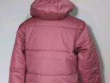 the back of a woman ' s pink jacket with a hood