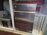 an image of a refrigerator and microwave in a room