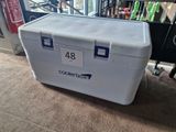 a cooler that is sitting on the floor in the room
