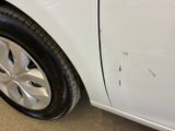 a close up of a tire on a white car