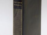 an old book is sitting on top of a white surface