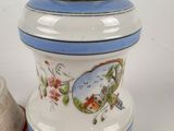 a picture of a salt and pepper shaker next to a thimble
