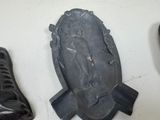 three pairs of shoes and a plaque on the wall