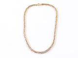 a close up of a necklace on a white surface
