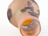 a vase with a flower design on it on a white surface