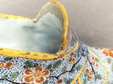 a close up of a shoe with a flower design on it